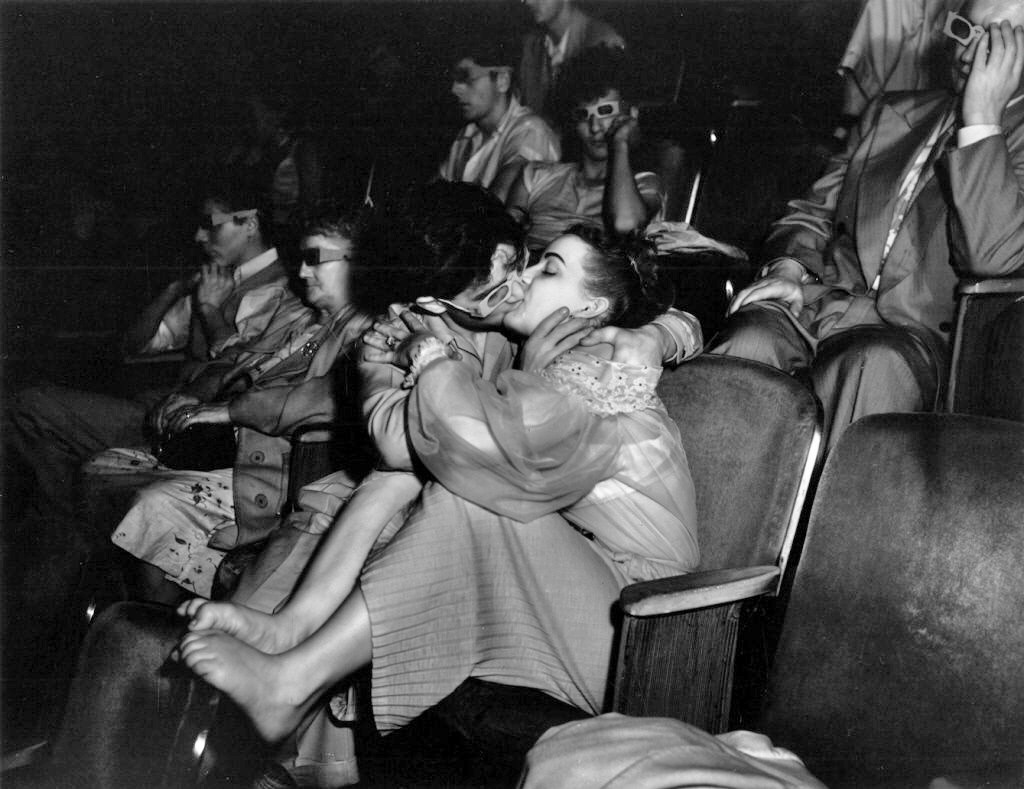 Weegee - Lovers with 3-D glasses at the Palace Theater, 1943